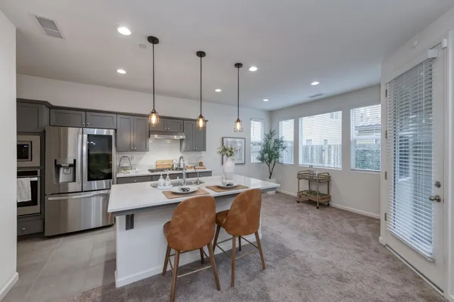 a large kitchen with a table and chairs