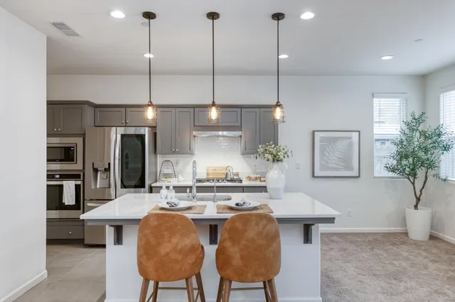 a view of kitchen with kitchen island dining table and chairs