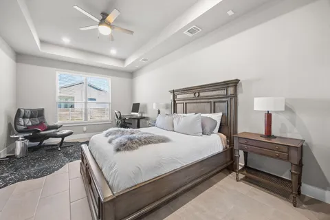 a bedroom with a bed couch and window