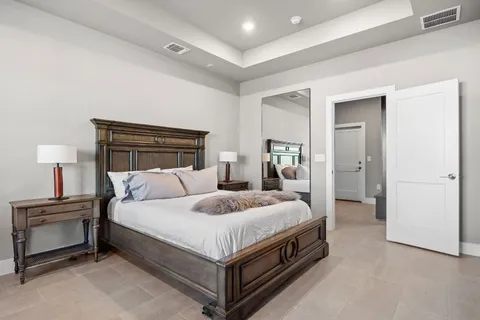 a bedroom with a bed and a lamp on table