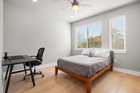a bedroom with a bed a chair and a chandelier