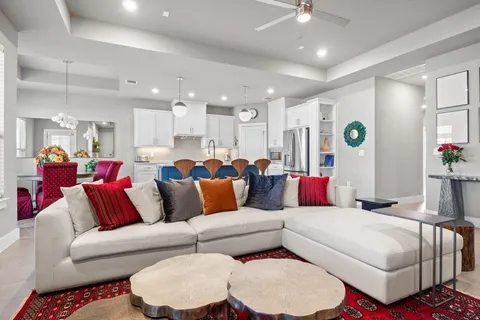 a living room with furniture and a view of kitchen