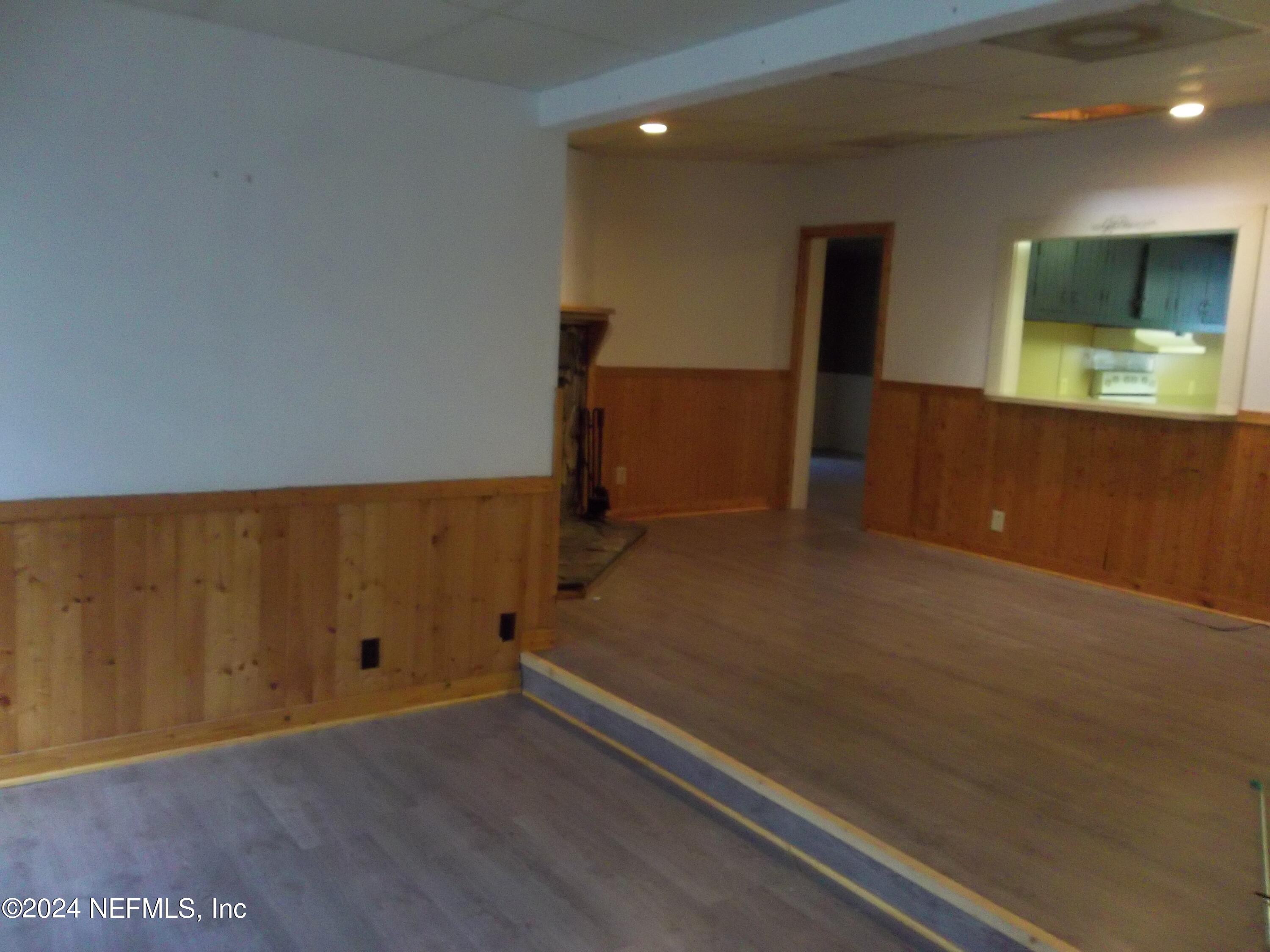 95182 Santa Juana Road Fernandina Beach, FL 32034 - Photo 3 of 20 an empty room with wooden floor and windows