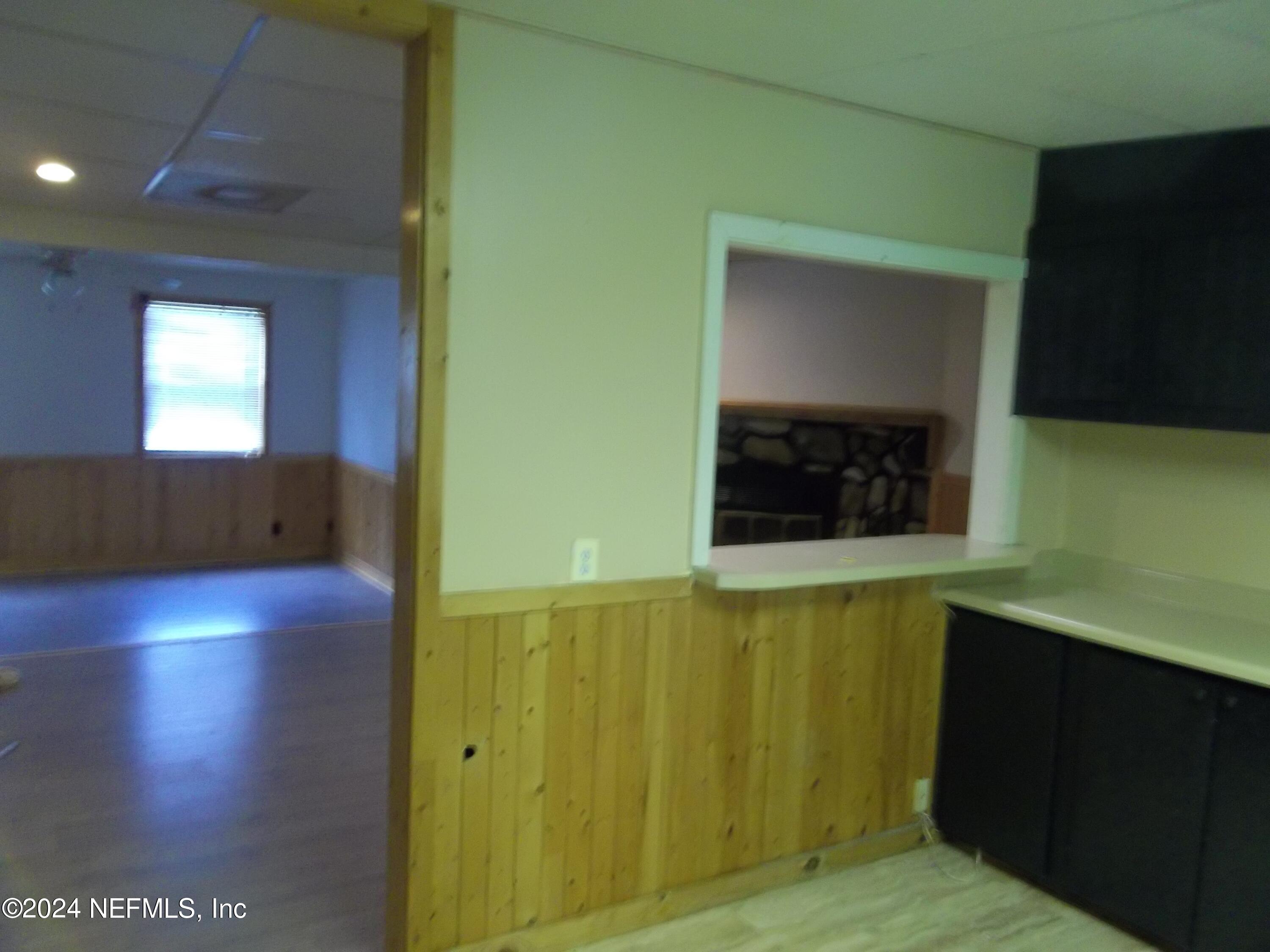 95182 Santa Juana Road Fernandina Beach, FL 32034 - Photo 6 of 20 a view of a hallway with wooden floor and a cabinet