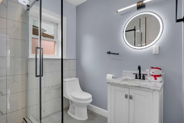 a bathroom with a toilet a sink and a mirror