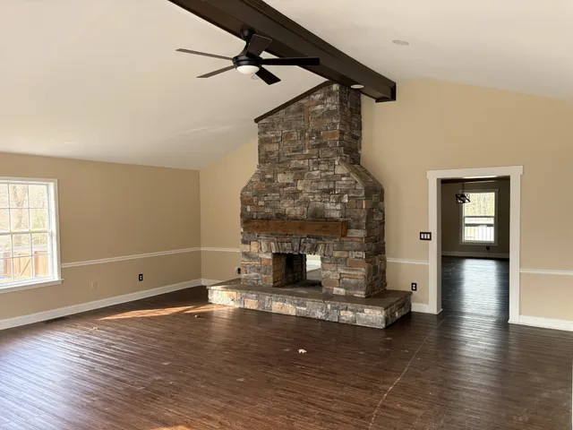 a living room with fireplace furniture and a wooden floor