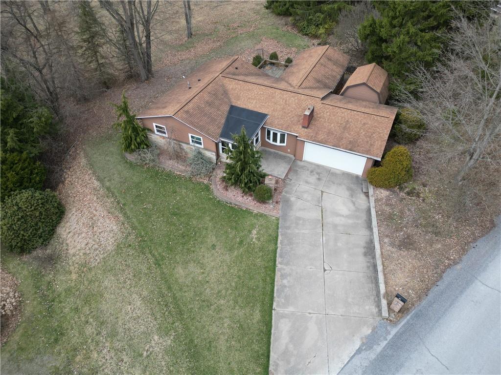 an aerial view of a house with a yard and garage