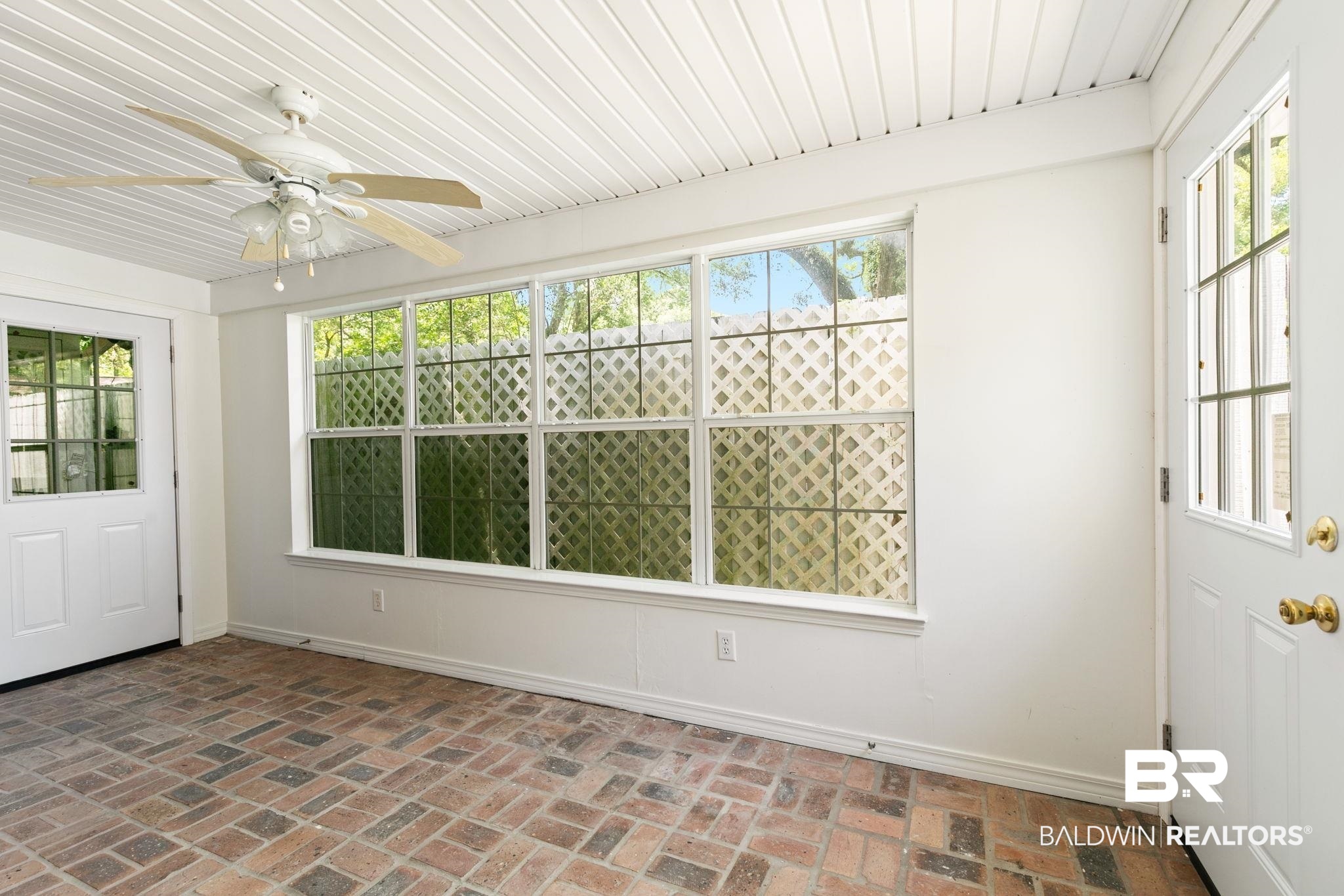 927 Cleveland Road Saraland, AL 36571 - Photo 36 of 80 Enclosed porch featuring brick flooring, beadboard ceiling, a ceiling fan with light fixture, and multiple windows