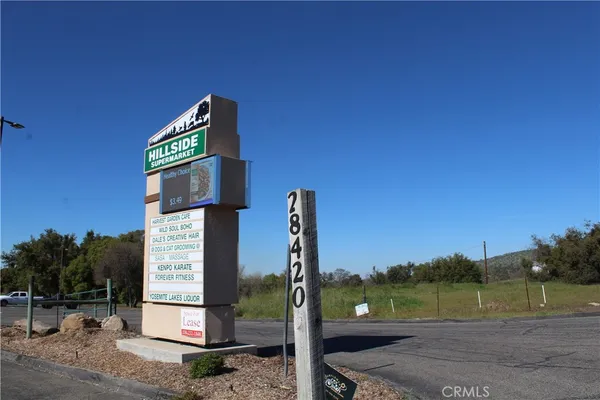 a street sign on a sidewalk next to a road