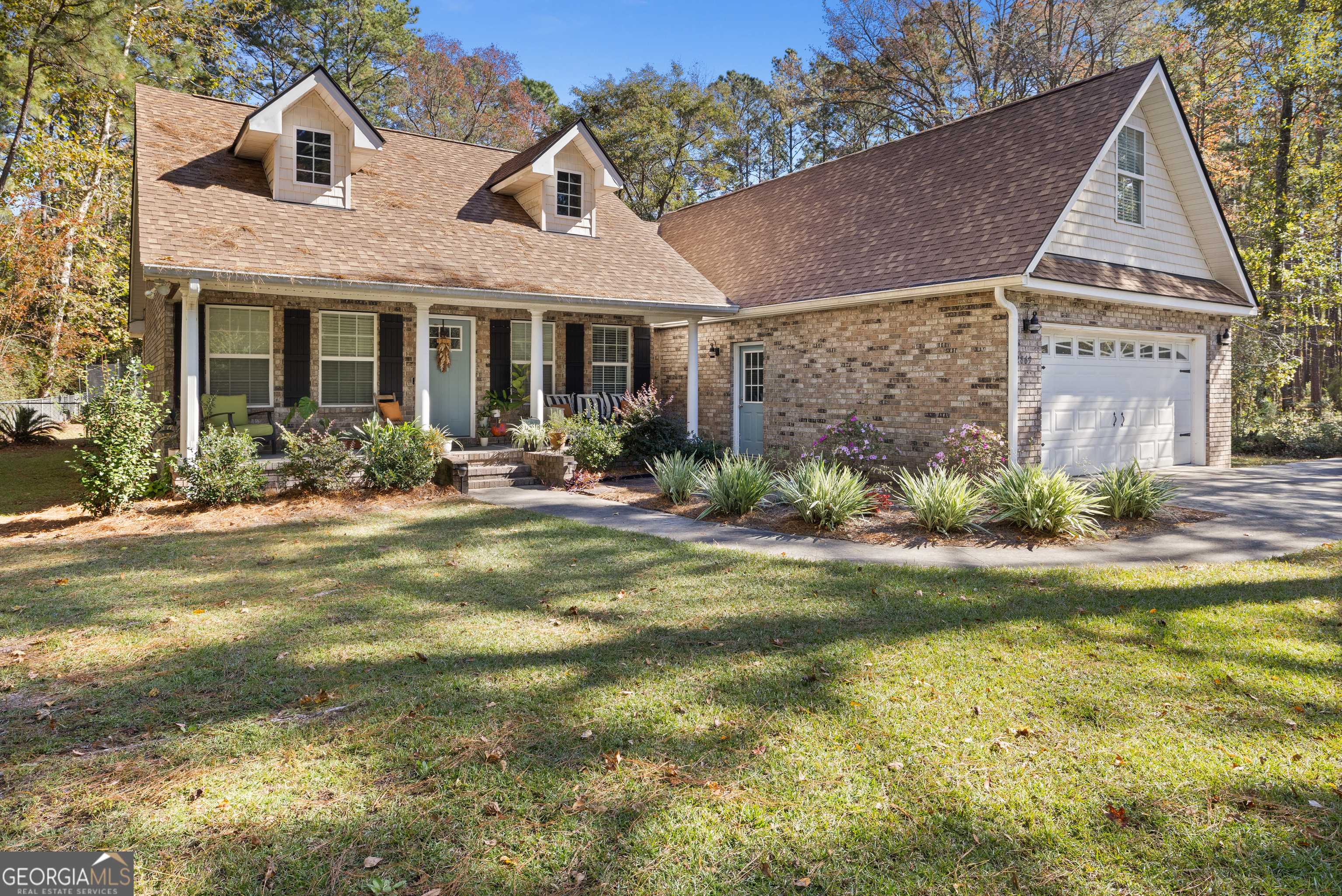 a front view of a house with garden