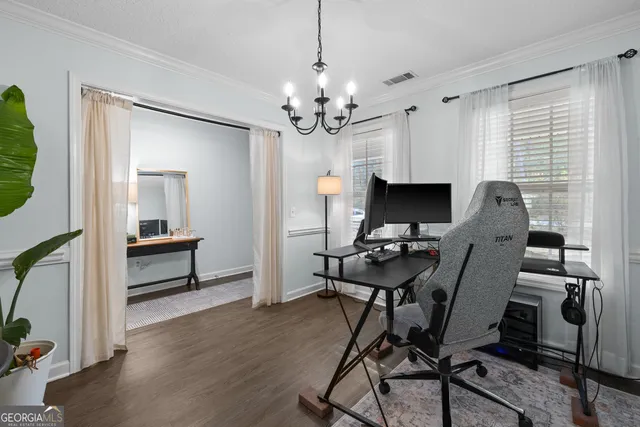 a view of a workspace with furniture and a window