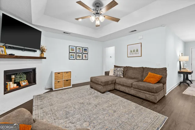 a living room with furniture a flat screen tv and a fireplace