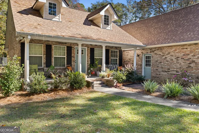 a view of a house with garden and patio