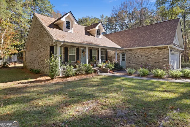 a front view of house with yard and green space