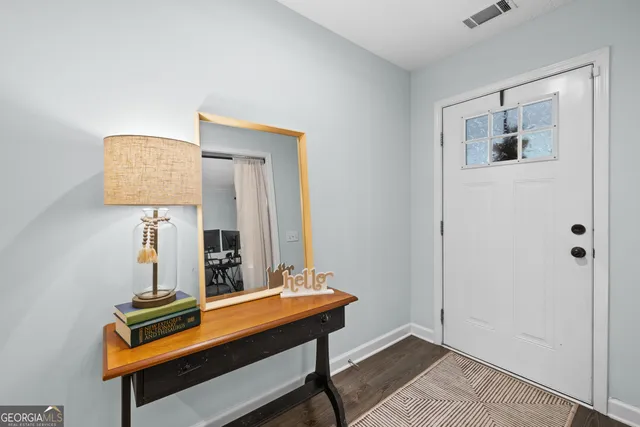 a room with painting on the wall and a table