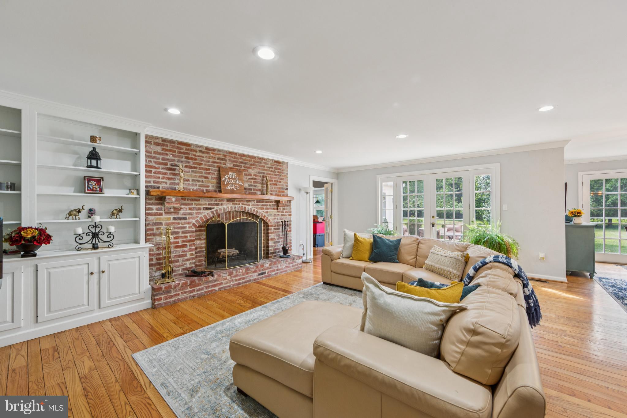 717 Evans Road Lower Gwynedd, PA 19002 - Photo 11 of 35 a living room with furniture large window and a fireplace