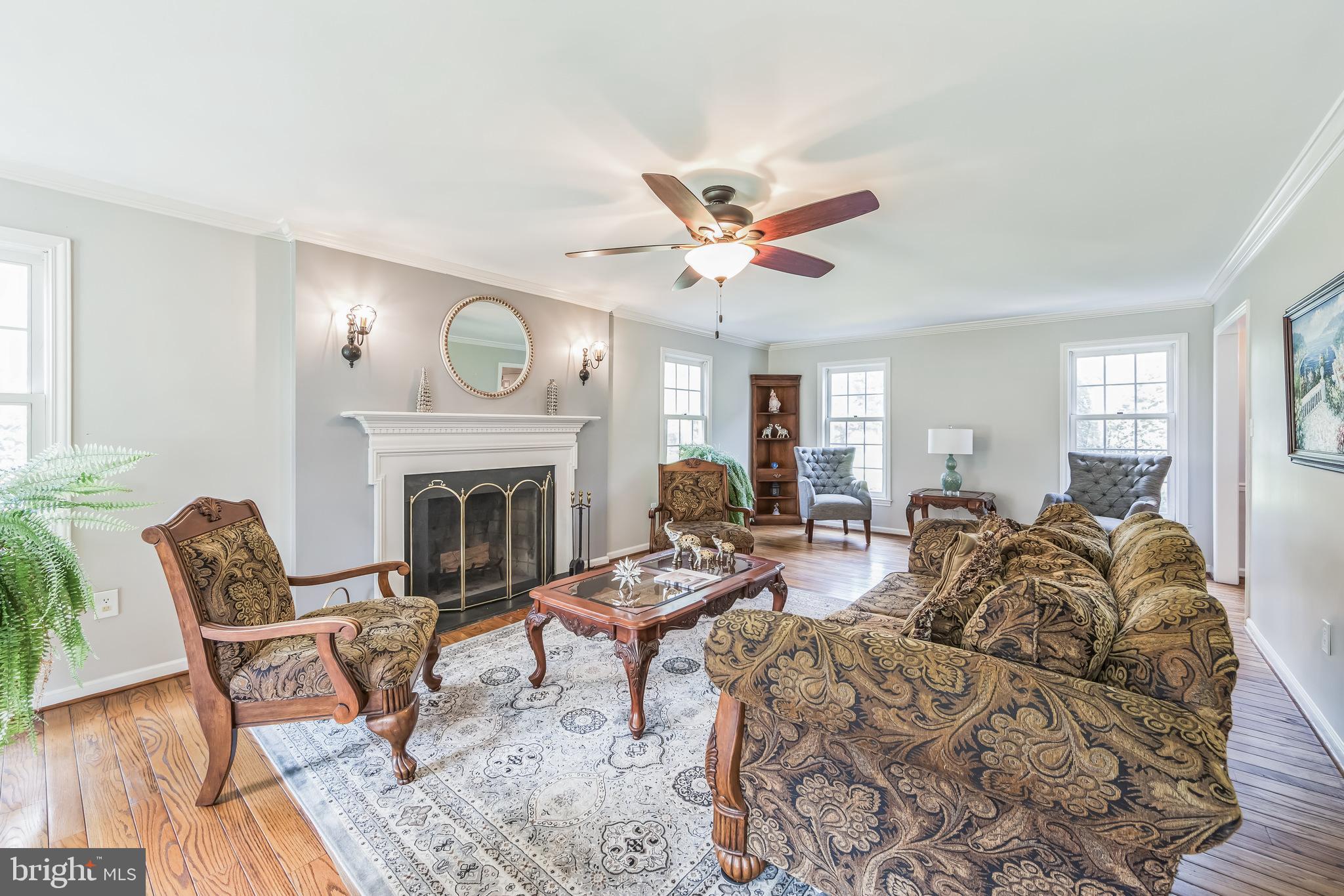 717 Evans Road Lower Gwynedd, PA 19002 - Photo 14 of 35 a living room with furniture a fireplace and a window