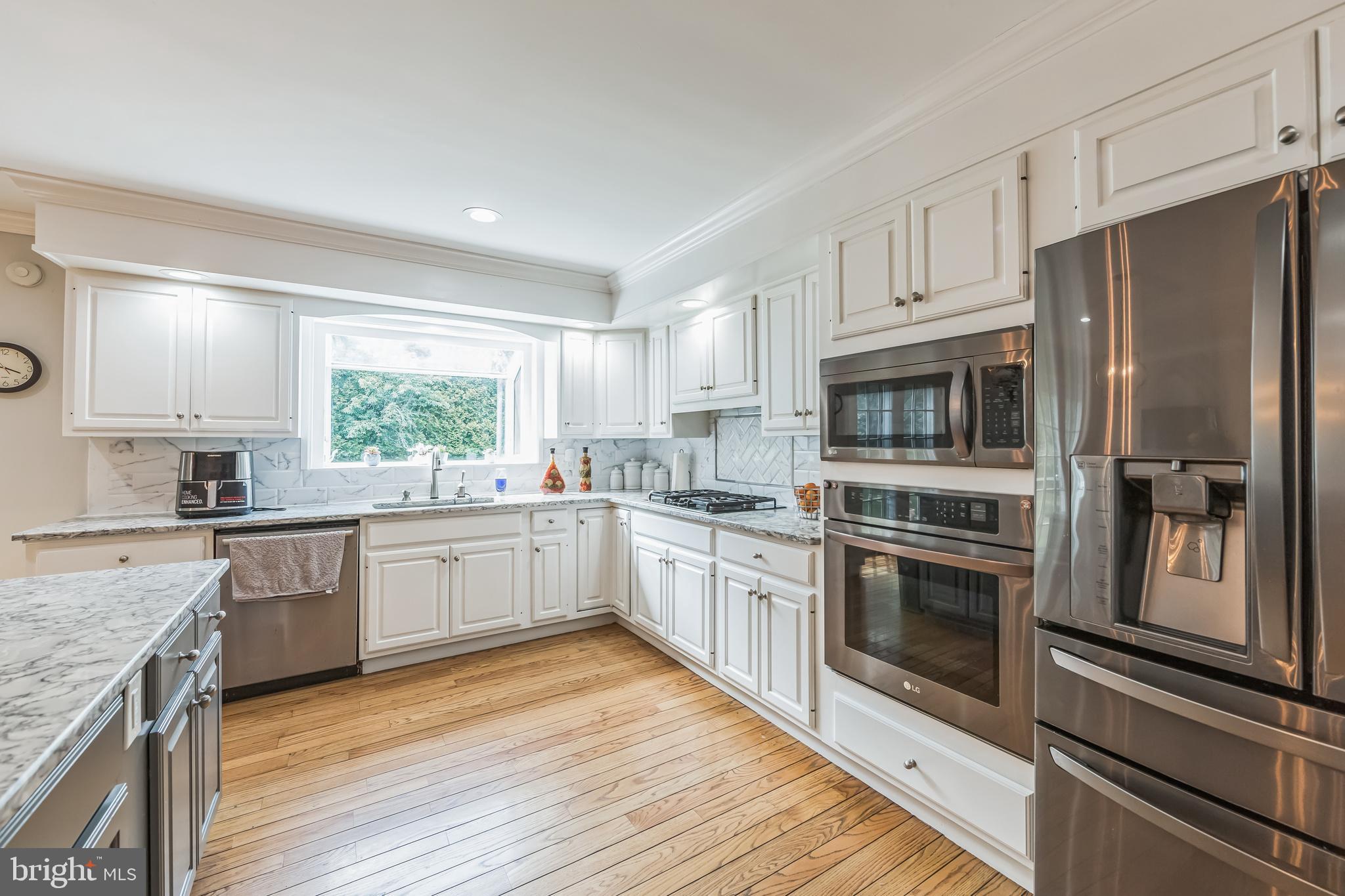 717 Evans Road Lower Gwynedd, PA 19002 - Photo 16 of 35 a kitchen with stainless steel appliances granite countertop a stove a sink and a refrigerator