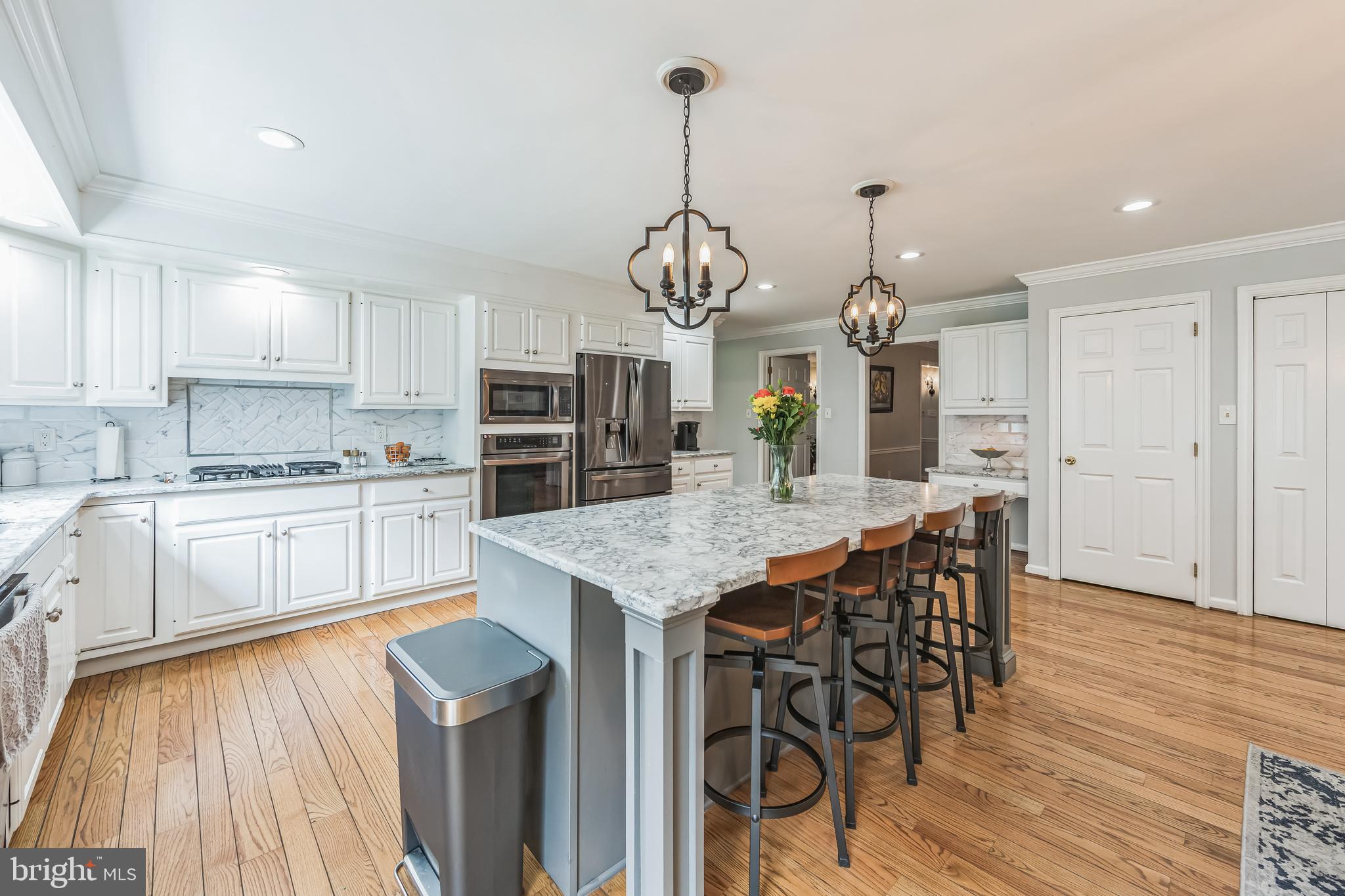 717 Evans Road Lower Gwynedd, PA 19002 - Photo 18 of 35 a kitchen with stainless steel appliances kitchen island granite countertop a kitchen island hardwood floor and a sink