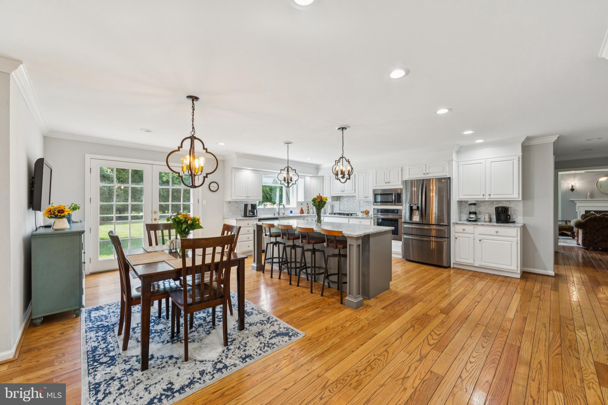 717 Evans Road Lower Gwynedd, PA 19002 - Photo 19 of 35 a view of a dining room and livingroom with furniture wooden floor kitchen view and a chandelier