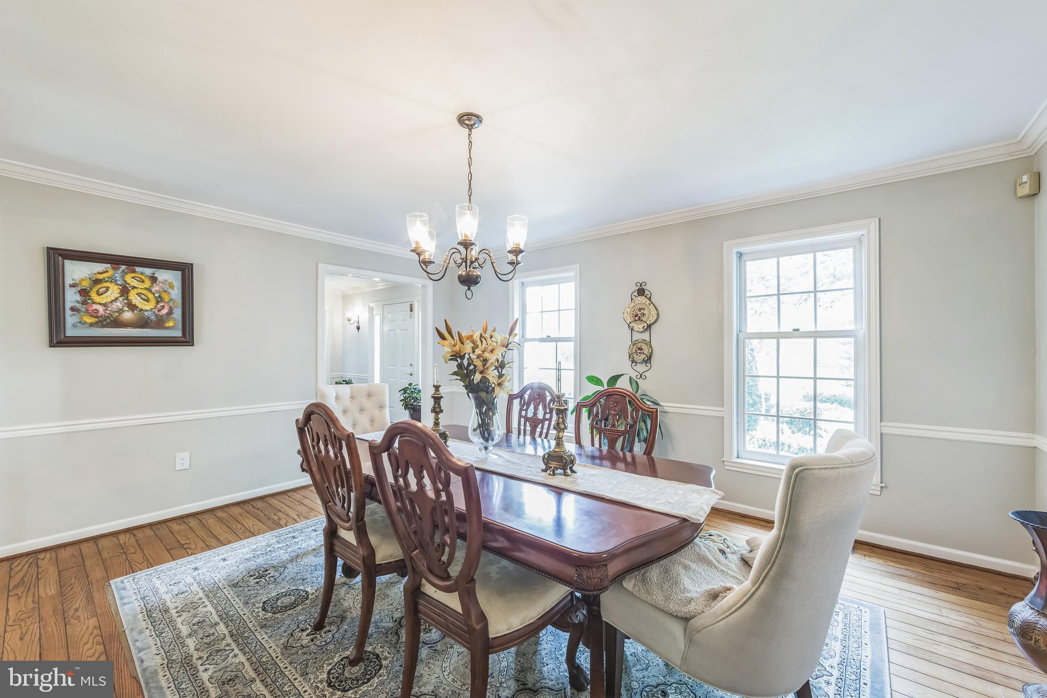 717 Evans Road Lower Gwynedd, PA 19002 - Photo 21 of 35 a dining room with furniture a chandelier and wooden floor