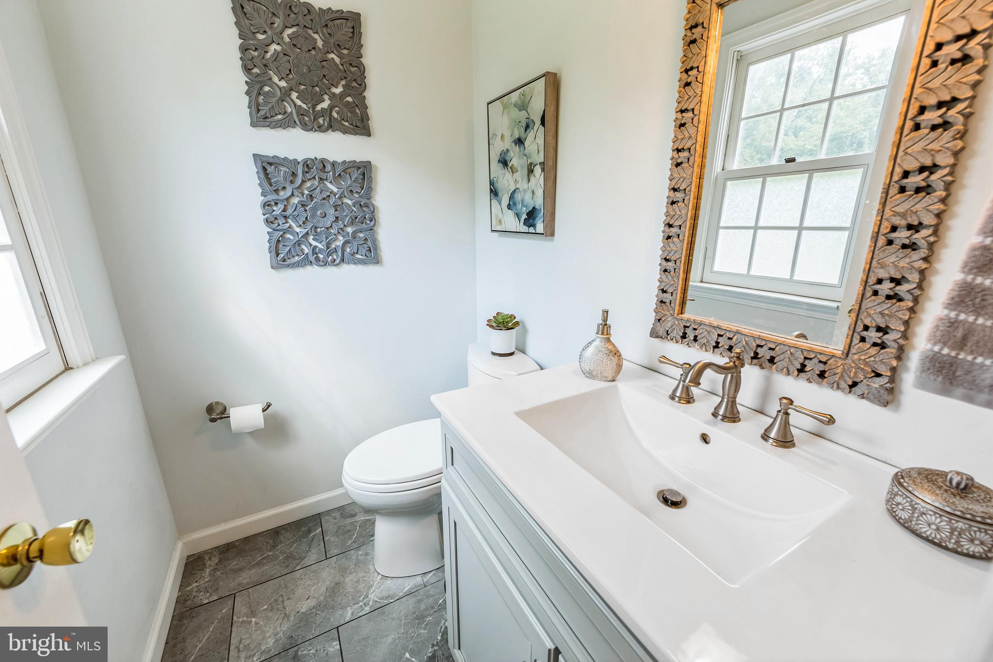 717 Evans Road Lower Gwynedd, PA 19002 - Photo 29 of 35 a bathroom with a sink a toilet and a mirror
