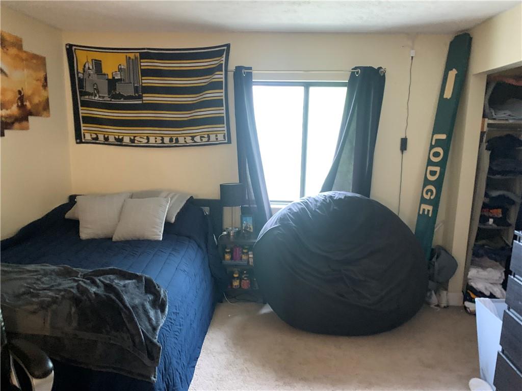 3246 Kennett Square Pittsburgh, PA 15213 - Photo 8 of 17 a bed sitting in a bedroom next to a window