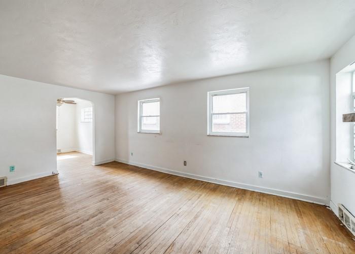 3721 Oakton Road Pittsburgh, PA 15227 - Photo 13 of 25 an empty room with wooden floor and windows