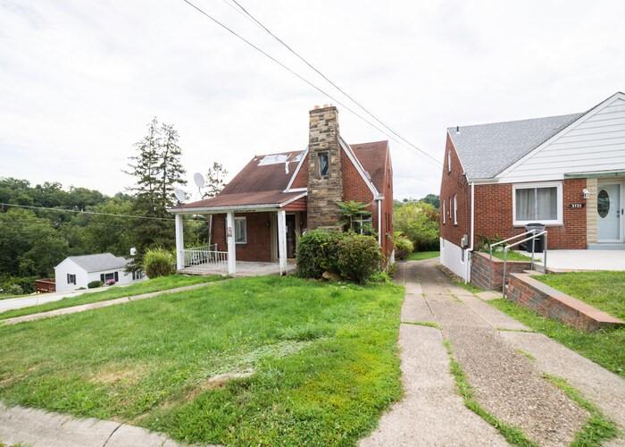 3721 Oakton Road Pittsburgh, PA 15227 - Photo 3 of 25 a front view of a house with a yard table and chairs