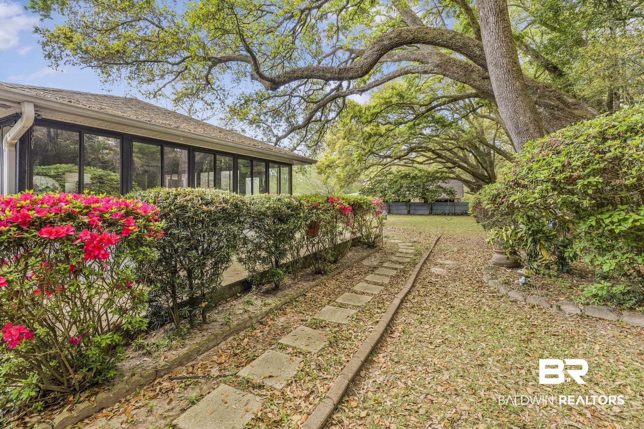 10207 Plantation Drive Daphne, AL 36526 - Photo 4 of 48 View of yard with a sunroom