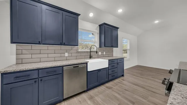a kitchen with stainless steel appliances granite countertop wooden cabinets a sink and dishwasher