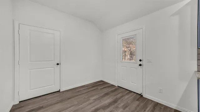 a view of an empty room and wooden floor