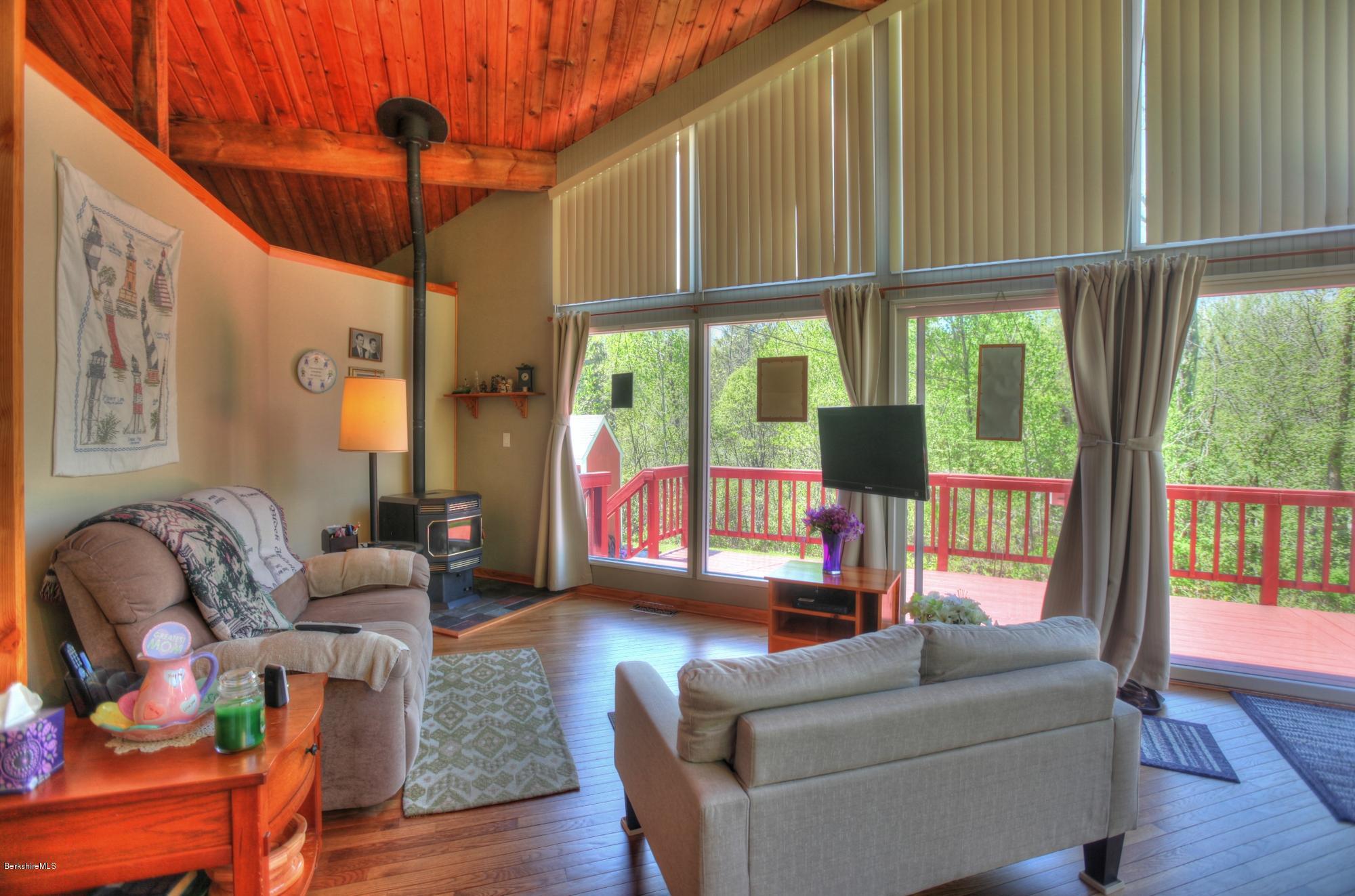 15 Dodd Road Sandisfield, MA 01255 - Photo 12 of 16 a living room with furniture a ceiling fan and a large window