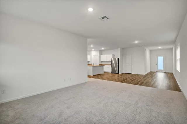 a view of kitchen and empty room