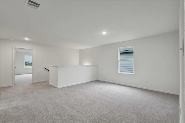 an empty room with a empty space and windows