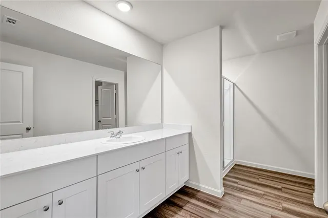 a bathroom with a double vanity sink and mirror