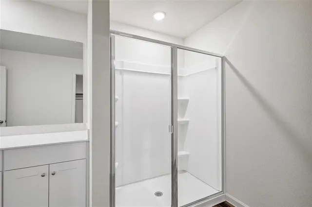 a bathroom with a glass shower door