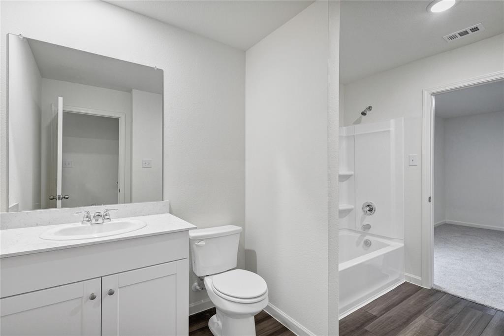 600 Merced River Lane Anna, TX 75409 - Photo 27 of 40 a bathroom with a sink a toilet and shower