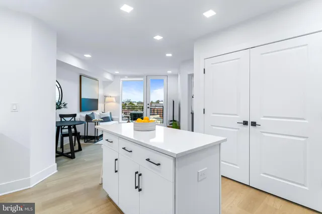 a view of kitchen with refrigerator sink and cabinets