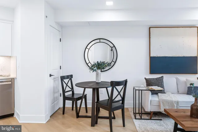 a living room with a table and a painting