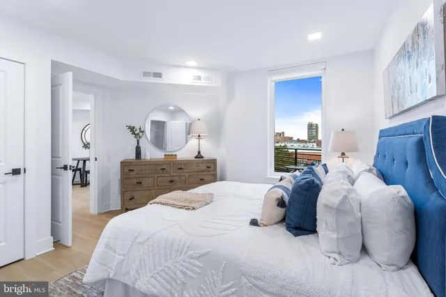 a bedroom with a bed and a mirror