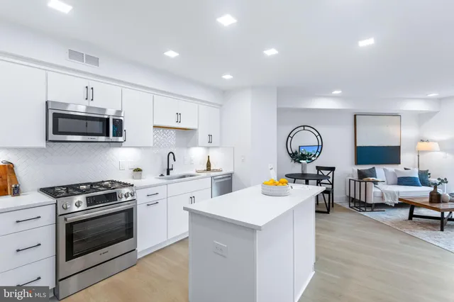 a kitchen that has a lot of cabinets in it and appliances