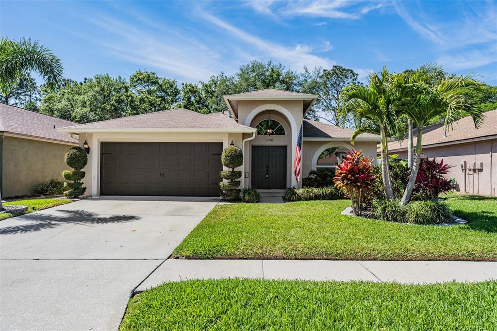 4710 Preston Woods Drive Valrico, FL 33596 - Photo 1 of 1 a front view of a house with a garden and plants