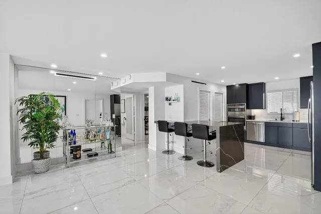 a view of kitchen with furniture and refrigerator
