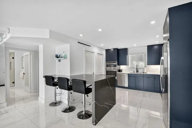 a large kitchen with a table and chairs