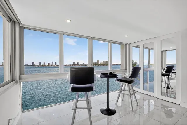 a living room with furniture a rug and a large window