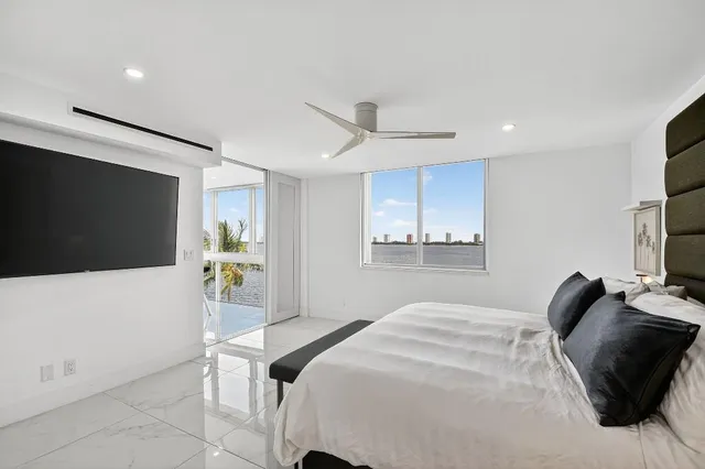 a bedroom with a bed and a flat screen tv