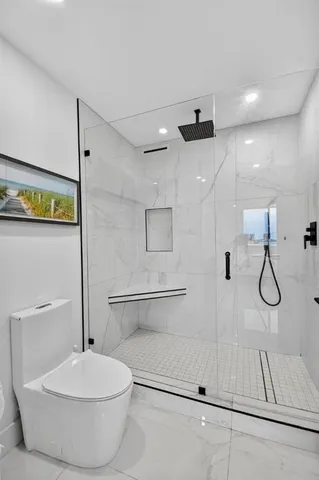 a bathroom with a toilet a sink and a shower