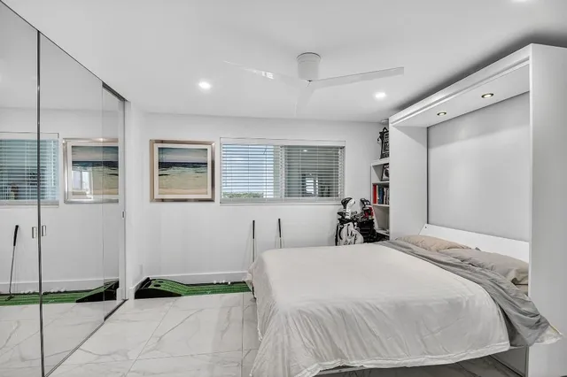 a bed room with a bed and a large mirror