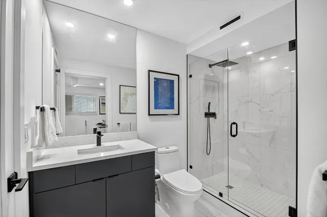 a bathroom with a sink toilet and shower